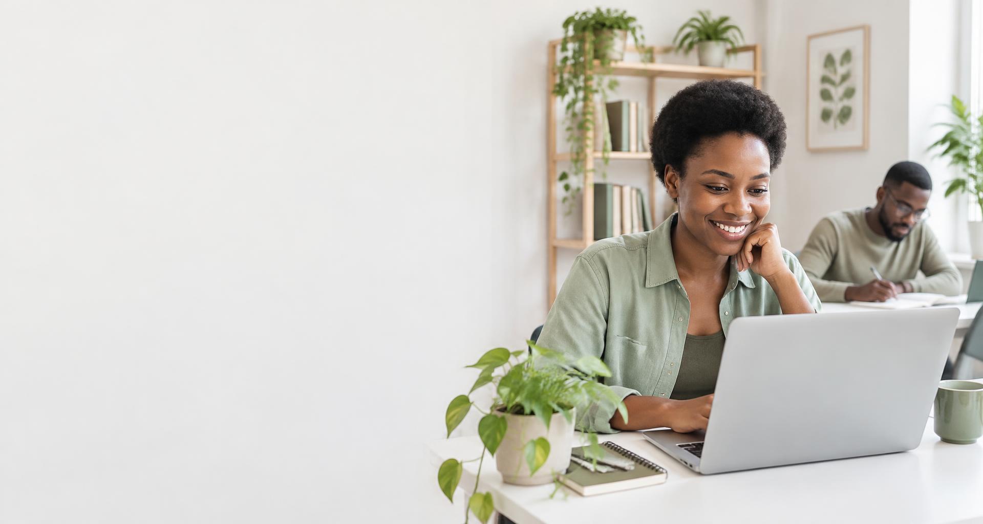 A learner exploring Python on her laptop in a bright study space